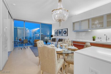 Dining room with a chandelier, a wall of windows,
