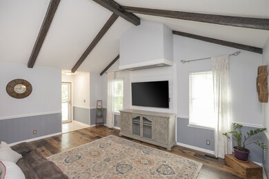 Feast your eyes on the beautiful wooden beams that adorn the vaulted ceiling, enhancing the overall charm and character of this living room. These beams effortlessly merge rustic warmth with modern aesthetics.