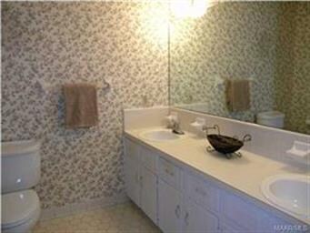 Master bath has double vanity & tiled shower