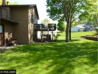 The rear yard has two tiers, a walk-down deck, and