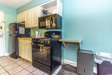 Kitchen featuring light tile patterned flooring, b