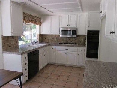 The kitchen has a view out onto the beautiful lawn