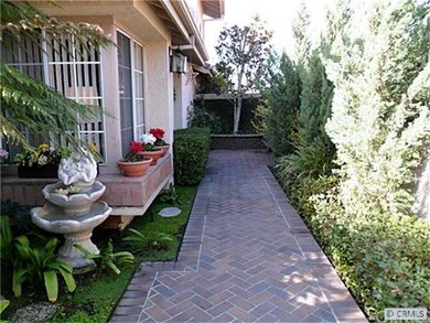 Private gated walkway leads to front entry.