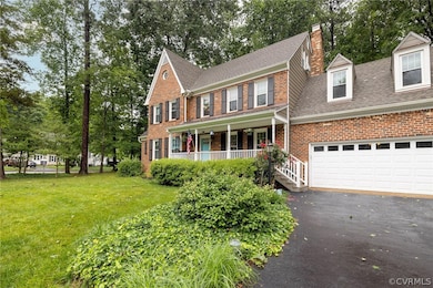 Colonial-style house with a front lawn, a garage,