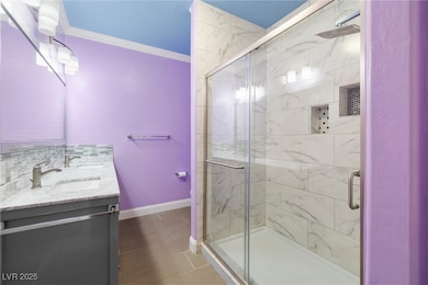 Full bathroom featuring ornamental molding, double