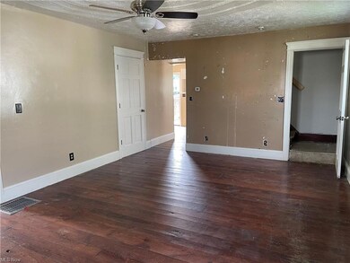 Hardwood floored spare room with a textured ceilin