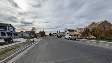 View of asphalt street with sidewalks, curbs, and a residential view
