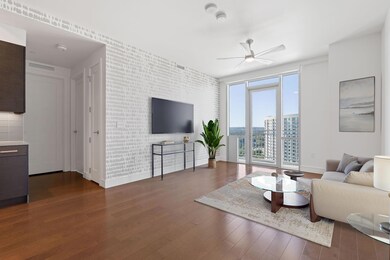 Living room featuring ceiling fan, baseboards, an
