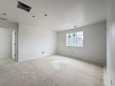 Empty room with baseboards and a textured ceiling