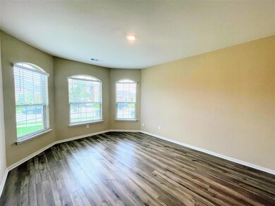 Empty room featuring visible vents, baseboards, an