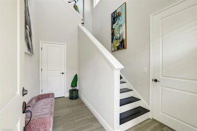 Stairway with hardwood / wood-style flooring