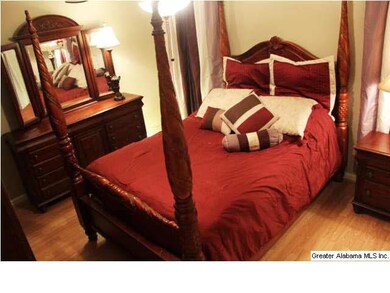 MASTER BEDROOM WITH LAMINATE HARDWOOD FLOORING AND