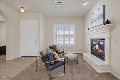Living area with a glass covered fireplace, basebo
