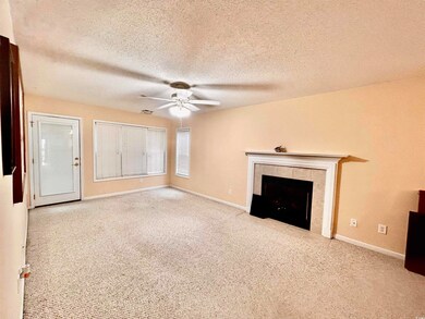 Unfurnished living room featuring a fireplace, lig