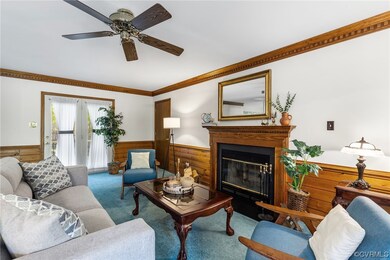 Carpeted living room with crown molding and ceilin