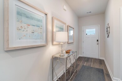 Doorway to outside featuring dark wood-type flooring and baseboards