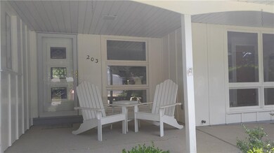 Relax and stay cool on the charming covered  front