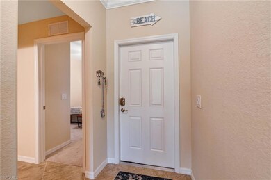 Entrance foyer with light tile patterned floors, a