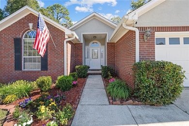 Entrance to property featuring brick siding and an attached garage