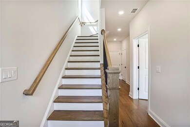 Stairs with wood finished floors, baseboards, and recessed lighting