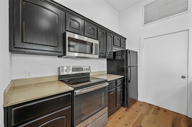 Kitchen with stainless steel appliances and light 