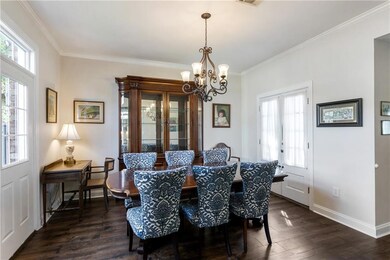 This elegant dining room features pristine white w