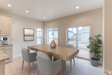 Dining room with light wood-style flooring and recessed lighting