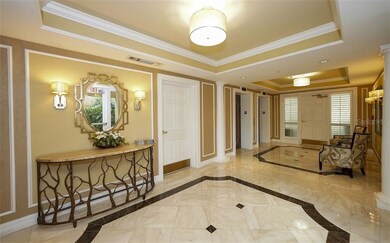 Lobby with marble floors and two elevators