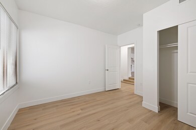 Unfurnished bedroom with light wood-type flooring and a closet