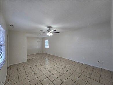 Spare room featuring light tile patterned floors and a ceiling fan