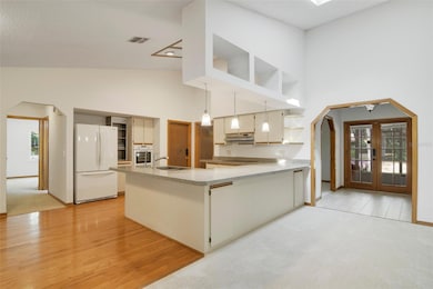 The family room is open to the kitchen where updates have also begun with GRANITE COUNTERTOPS and a new cooktop.