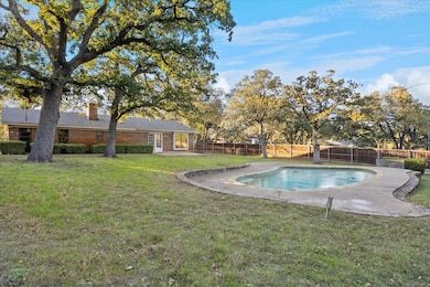 View of swimming pool featuring a patio and a fenced backyard