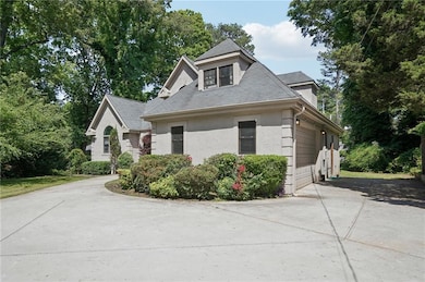 View of side of home featuring driveway, a garage,