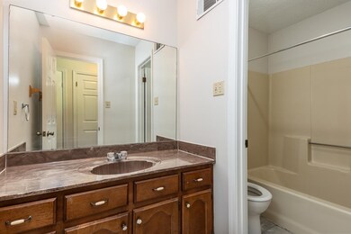 Full bathroom featuring vanity, a textured ceiling