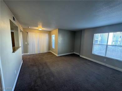 Unfurnished room featuring baseboards, visible ven
