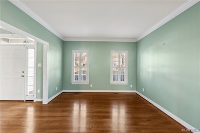 Formal living room off of the foyer w/ crown moldi