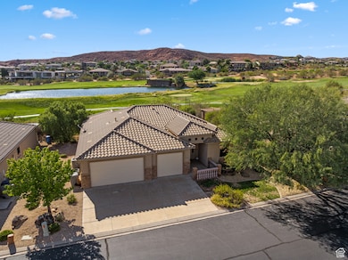 Aerial view of residential area with a water and mountain view and a golf club