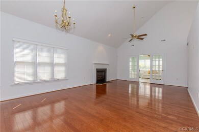 Unfurnished living room with high vaulted ceiling,
