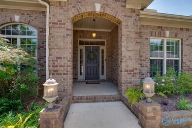 Be greeted by GORGEOUS landscaping around the covered front porch - beautifully illuminated by multiple lights at night, too!