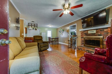 As you enter the front door you are greeted with this open living room and beautiful brick fireplace.