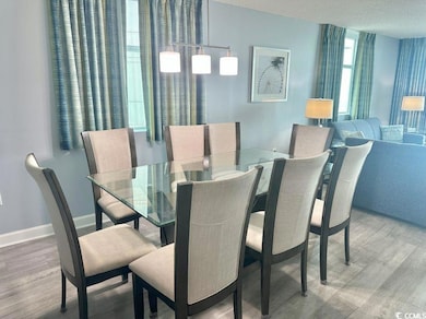 Dining room featuring wood finished floors and a textured ceiling