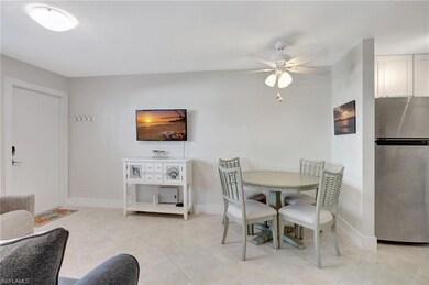 Dining space featuring ceiling fan and light tile 