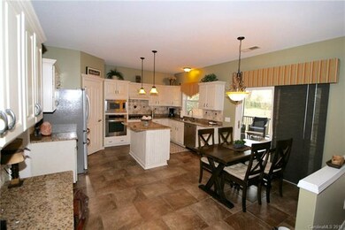 Large kitchen featuring granite countertops, natur