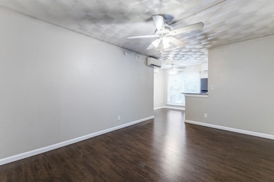 Unfurnished room featuring dark wood finished floors and ceiling fan