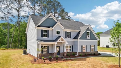 Craftsman-style house featuring brick siding, a front yard, and covered porch