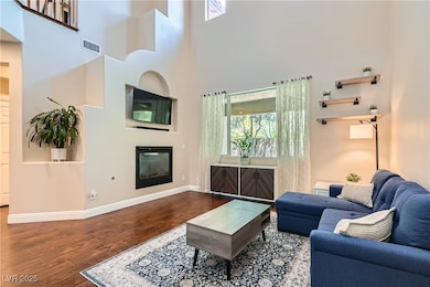 Living area featuring wood finished floors, basebo