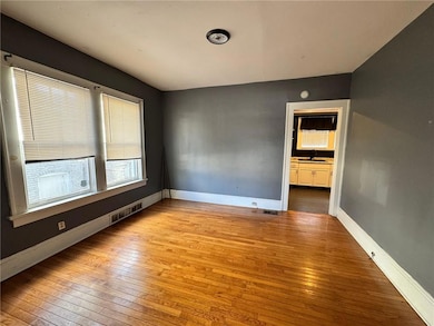 Spare room with sink and light wood-type flooring