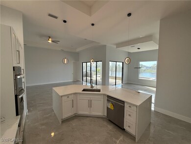 Kitchen featuring ceiling fan, dishwasher, sink, d