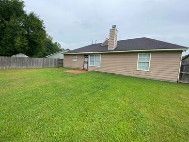Rear view of house with a lawn