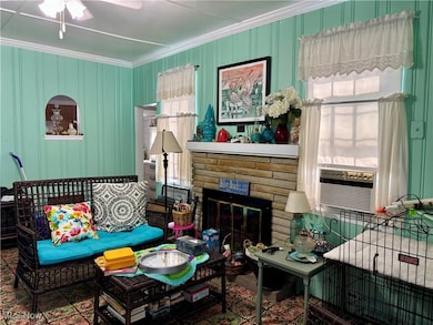 Living room featuring a wood burning fireplace.